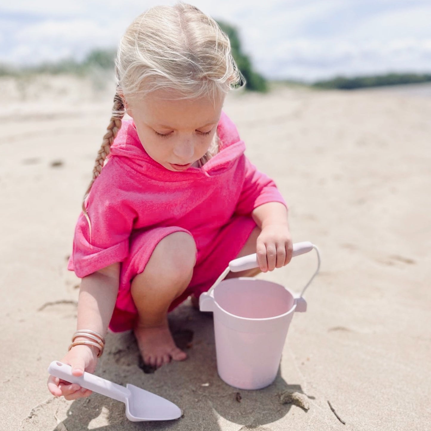 Toddler in hot pink hooded towel and shorts beach set