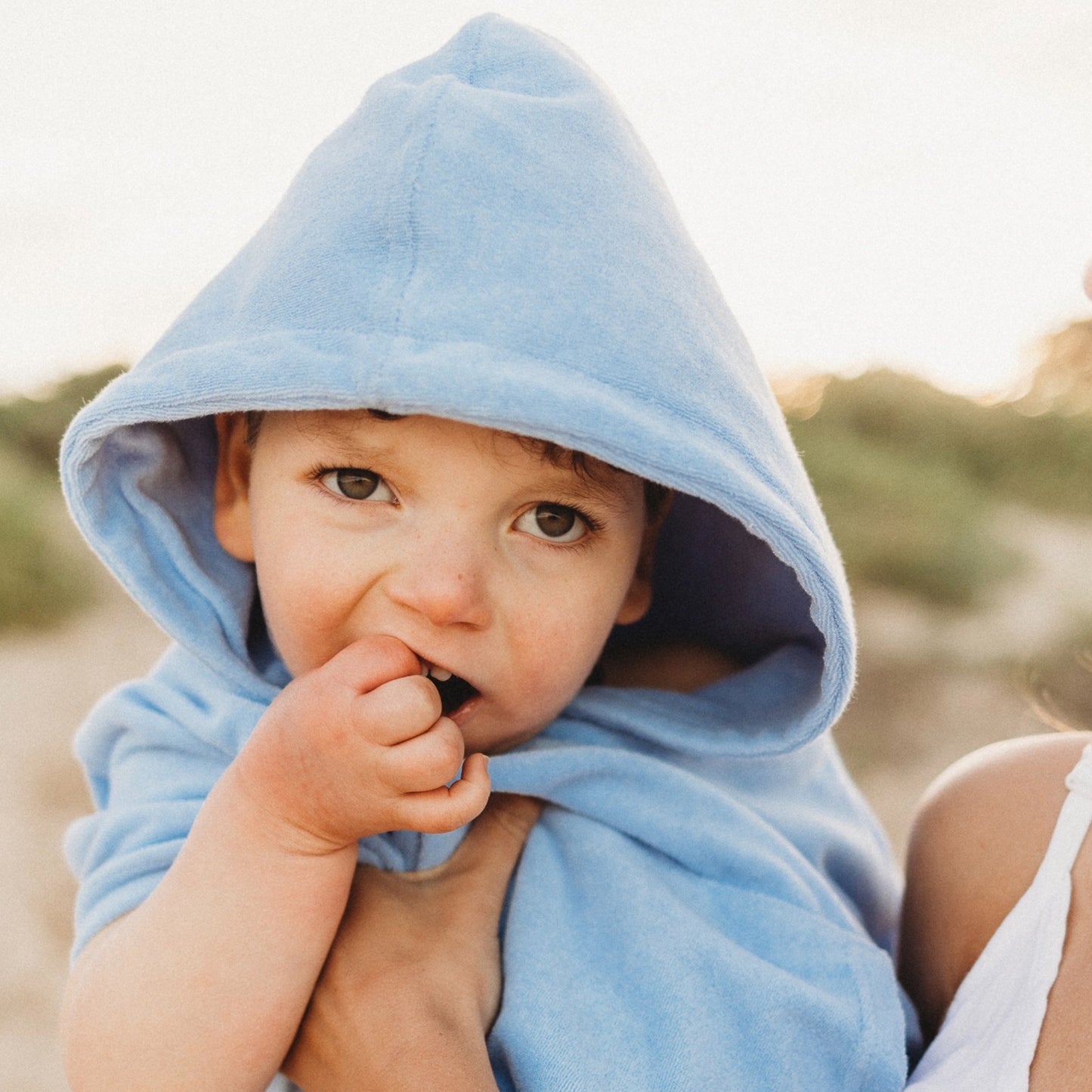 Toddler in blue Terry towelling hooded towel